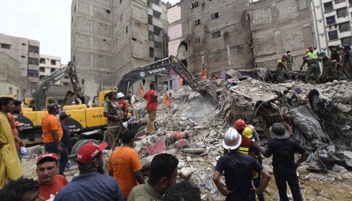 Rescue workers search for victims under the rubble after a five-story residential building collapsed in Karachi on July 04, 2025. — INP