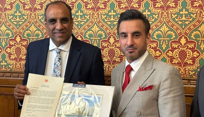 Lord Shaffaq Mohammed (left) presents an achievement award to British-Pakistani entrepreneur Shafiq Akbar at a ceremony at the House of Lords. —Reporter/Murtaza Ali Shah/File