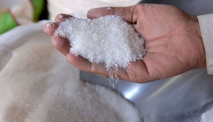 A person checking quality of sugar. —APP/File