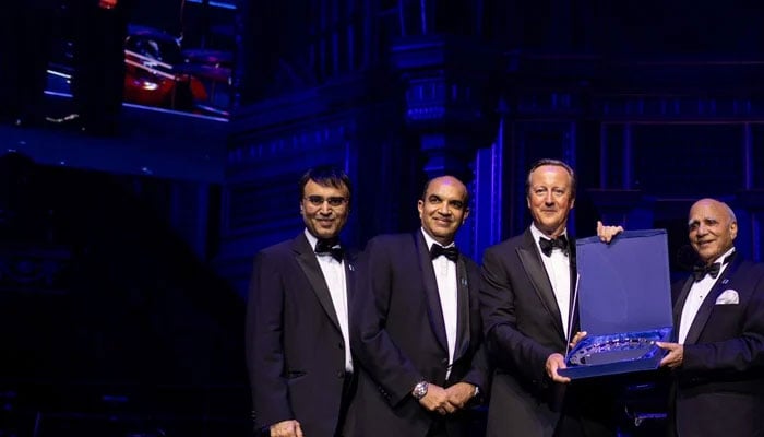 Former UK prime minister Lord David Cameron (centre-left) gives an award to Bestway Group founder, Sir Anwar Pervez OBE (centre-right), during the celebration of the 50th anniversary of Bestway Group at the Royal Albert Hall, London, Britain. — Reporter