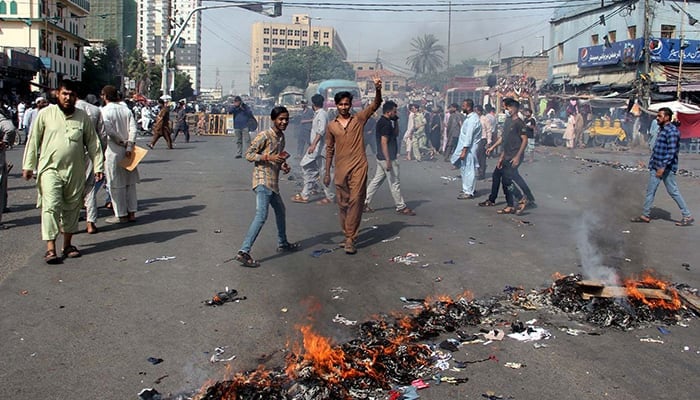 Traders, shopkeepers, and residents block roads and burn tyres and bushes during a protest against electricity loadshedding in Karachi, on May 27, 2024. — PPI