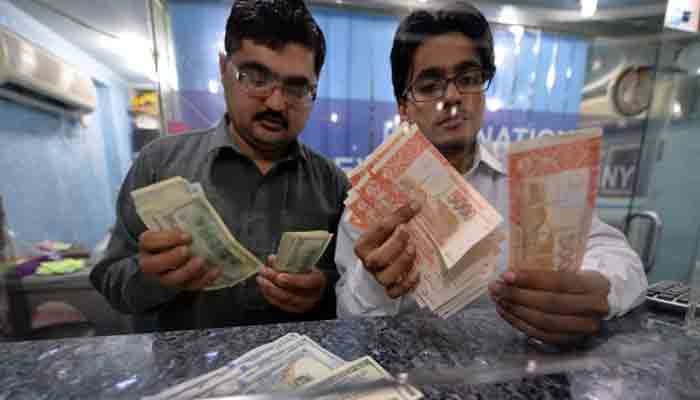 Forex dealers counting currency notes in this undated photo.—TheNews/File