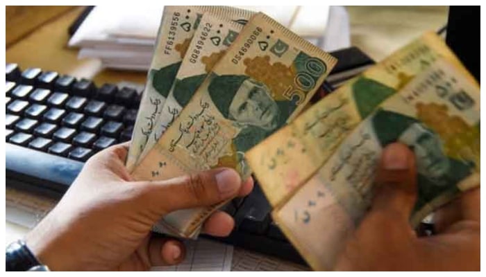 A representational image of a currency dealer counting Rs500 notes. — AFP/File
